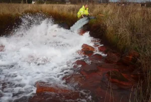 Sampling a pumped outflow from an abandoned coal mine in East Lothian. BGS © UKRI.