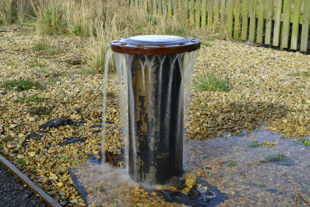 A borehole overflowing with water.