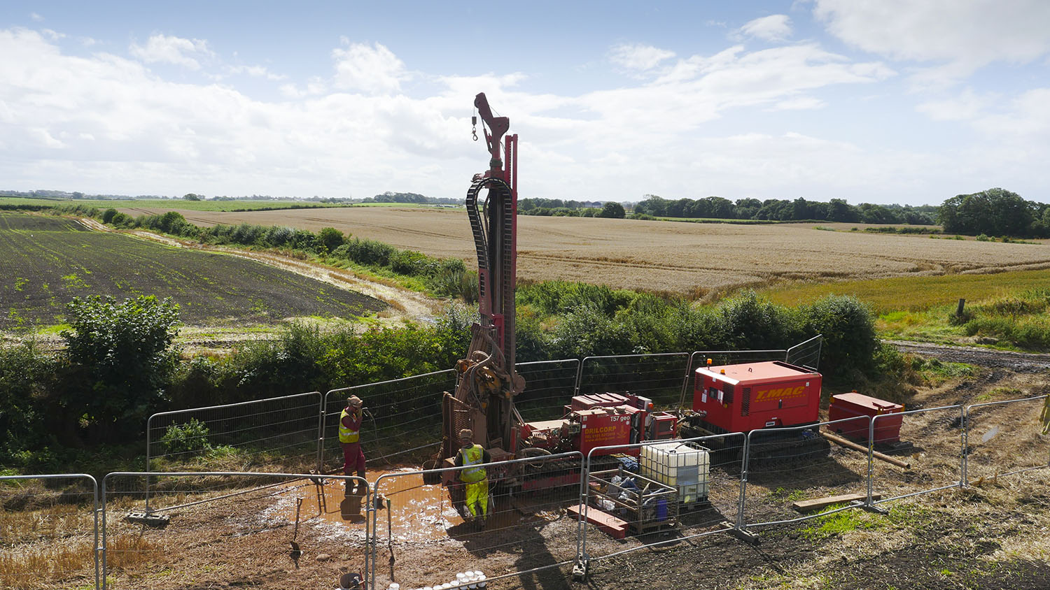 A borehole drilling machine in a muddy field