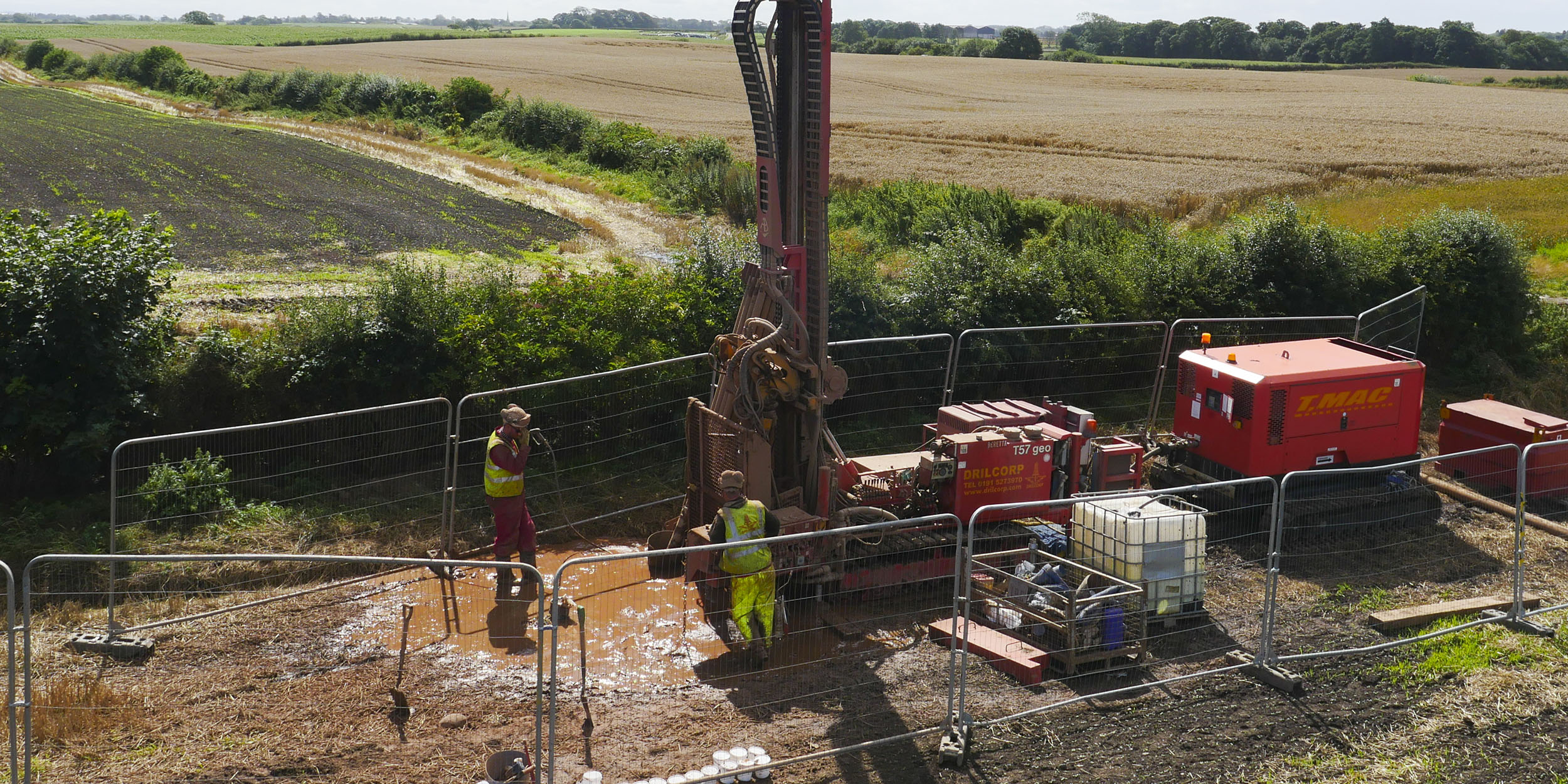 A borehole drilling machine in a muddy field