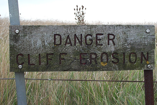 Danger cliff erosion sign.