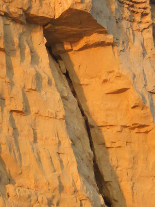 Wide cracks are visible in the rock face and leave unsupported blocks of rock free to fall. Taken 25 July 2012.