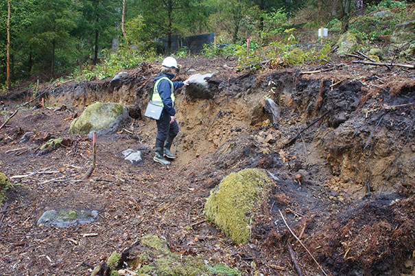 Dr Claire Dashwood of the BGS Landslide Response Team investigating the head of the landslide above the B6344, east of Rothbury, Northumberland.