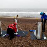 Coastal team members setting up the portable devices used to measure sediment transport on mixed sand and gravel beaches at Minsmere, East England, UK (more info about the device here: https://doi.org/10.1016/j.coastaleng.2019.103580)