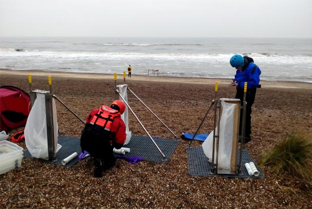 Coastal team members setting up the portable devices used to measure sediment transport on mixed sand and gravel beaches at Minsmere, East England, UK (more info about the device here: https://doi.org/10.1016/j.coastaleng.2019.103580)