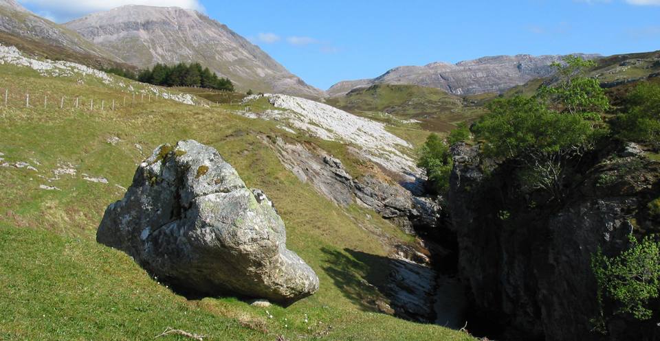 Glacial erratic of Lewisian Gneiss above Traligill Rising. This boulder would have been deposited at the ice front of the retreating glacier.