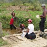 People taking water samples in a river in Madagascar
