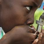 boy-drinking-water-on-faucet