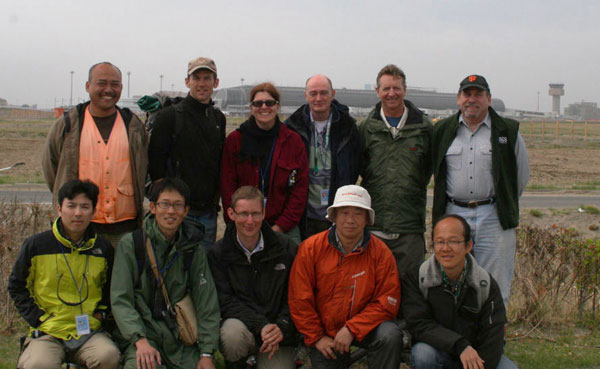 Members of the May 2011 international tsunami survey team near their main survey transect; Sendai Airport is in the background. Click to enlarge and for team member details