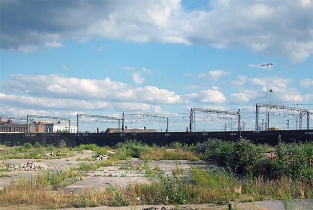 A Large Unused Urban Brownfield Site With Open Land Covered In Cracked Overgrown Concrete Awaiting Development In Leeds England Stock Photo. Philip Openshaw. Canva.