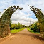 A modern sculpture of teo curved half arches in Cunigar Loop Park, Glasgow