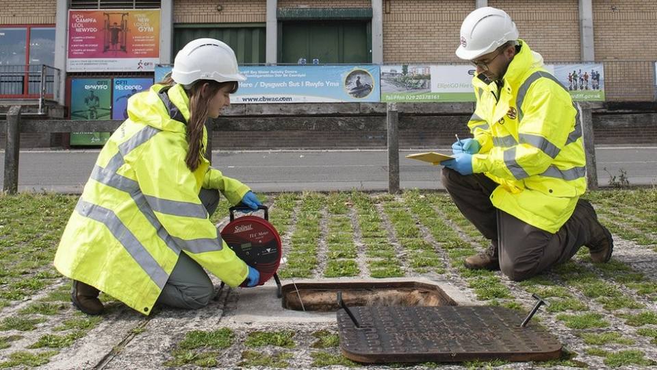 Two geologists looking at equipment from a borehole