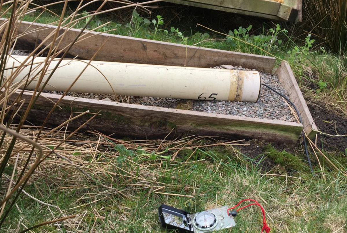 Induction coil on a gravel foundation (compass denotes orientation)