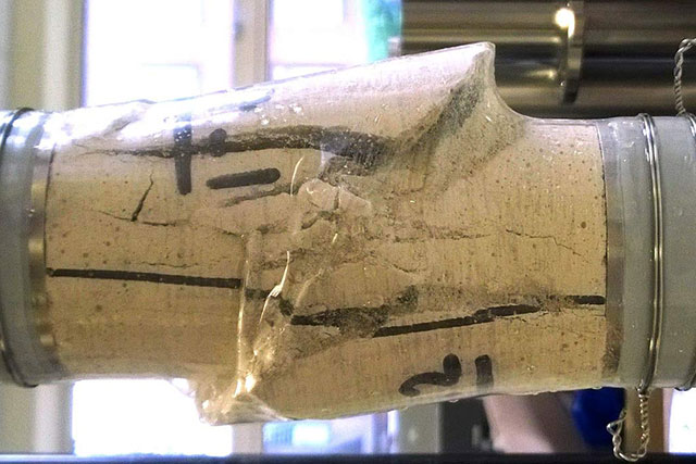 A piece of sandstone rock that has been sheard by pressure applied in a laboratory setting
