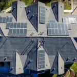 An aerial view of solar panels on top of houses