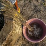 Pouring drinking water from a well in Mozambique