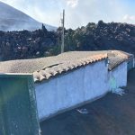 A huge pile of blocky a'a lava approached a small white building