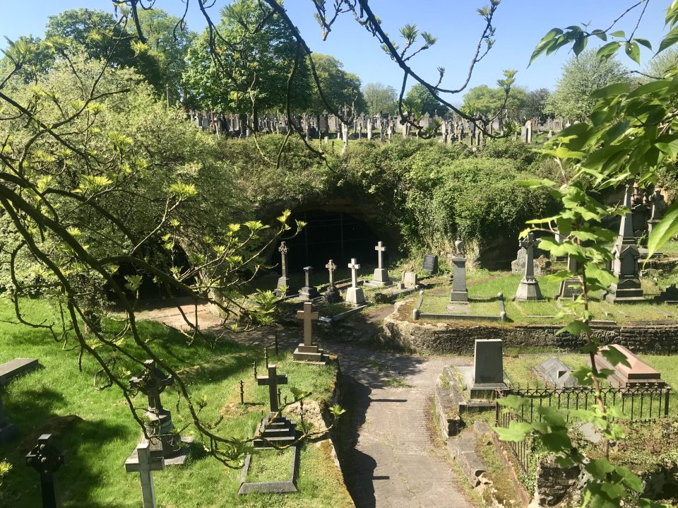 Caves and tunnels dug into the a cliff in a graveyard