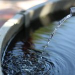 Drops of water falling into a container