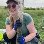 PhD student Megan Trusler (University of Nottingham) looking pleased to have recovered the first sediment core of the fieldtrip. Photo by Chris Vane. BGS © UKRI.