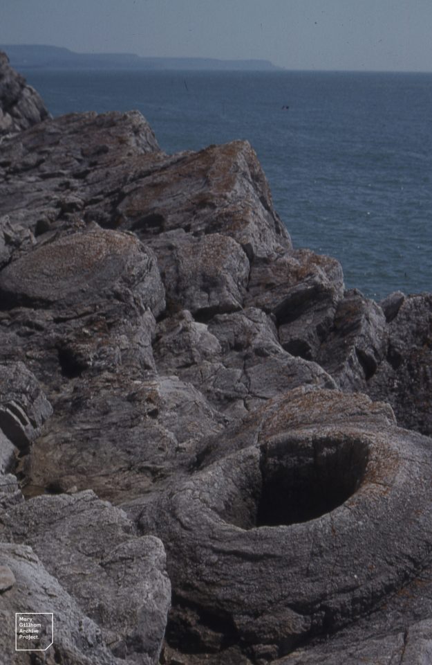 a circular, bowl-like depression in grey rock
