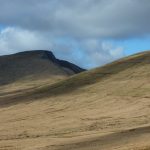 A panorama of three flat-topped hills