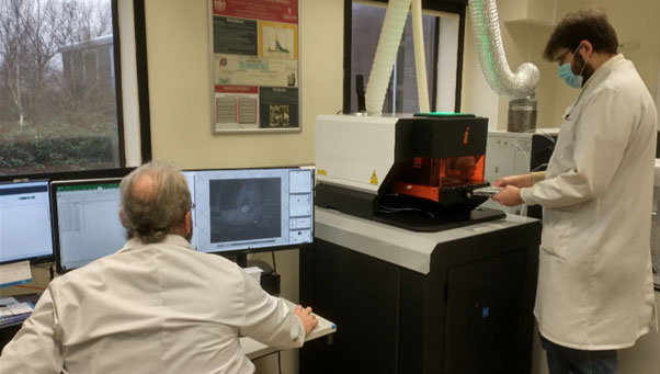 Figure 2: The new imageGEO193 LA unit coupled to the 8900 series ICP-MS. Andrew Marriott (left) is operating the workstation computer whilst Elliott Hamilton (right) loads a new sample into the LA. The ICP-MS is in the background right. BGS © UKRI