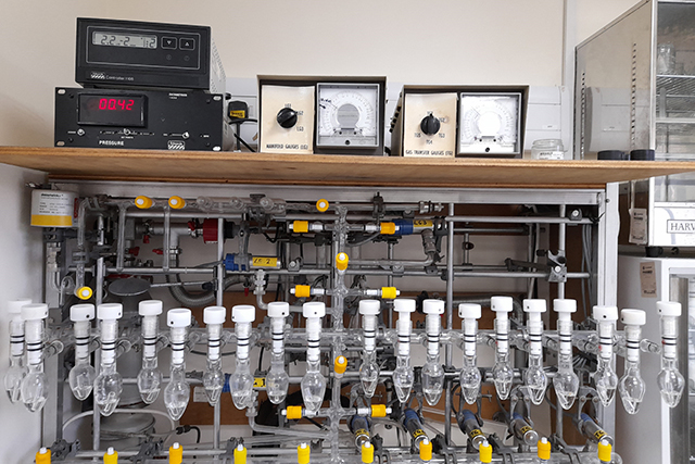 A row of bulb-shaped glass vials containing clear, colourless liquid