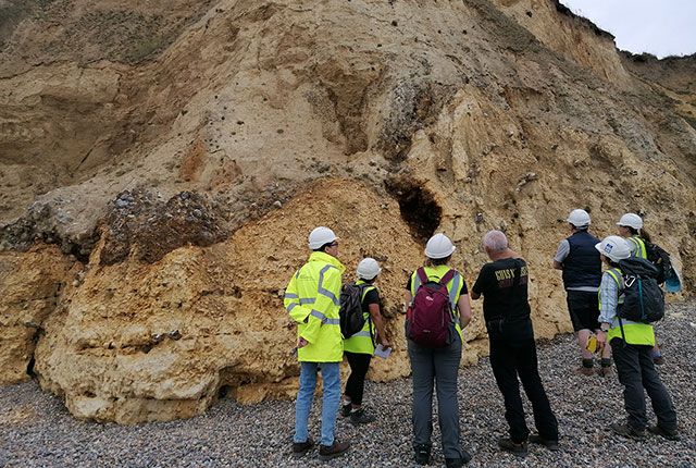 Looking at the structures within the periglacially altered Wroxham Crag Member and Chalk Group exposed at Weybourne. Catriona Macdonald and Sarah Arkley, BGS © UKRI.