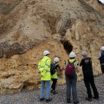 Examining the glacial sediments exposed in the cliffs at Happisburgh. Sarah Arkley, BGS © UKRI.