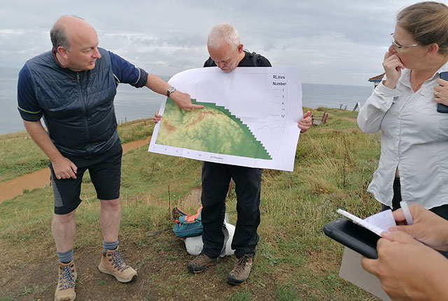 Jon explains the glacial geomorphology that can be seen from the top of Skelding Hill.  Catriona Maca\zAdonald and Sarah Arkley, BGS © UKRI.