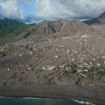 The town of Plymouth, the capital of Montserrat in the Lesser Antilles, has been buried by repeated pyroclastic density current and tephra fall events from the Soufrière Hills Volcano (in the background). Repeated pyroclastic density currents and lahars (volcanic mudflows) have extended the land, creating a new coastline. BGS © UKRI.