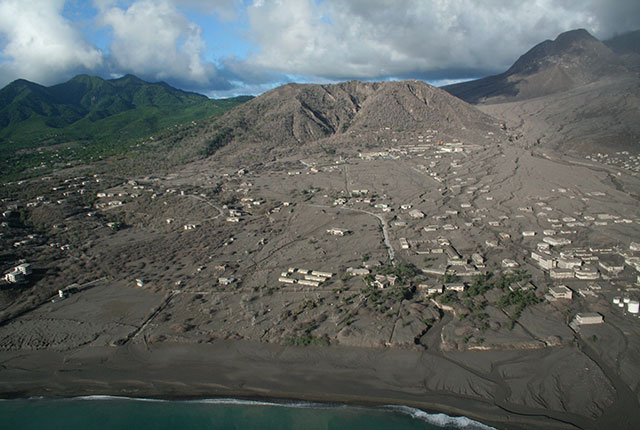 The town of Plymouth, the capital of Montserrat in the Lesser Antilles, has been buried by repeated pyroclastic density current and tephra fall events from the Soufrière Hills Volcano (in the background). Repeated pyroclastic density currents and lahars (volcanic mudflows) have extended the land, creating a new coastline. BGS © UKRI.