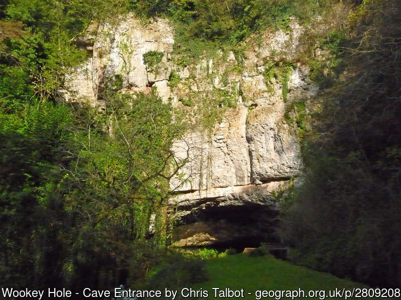 A low cave at the base of a sheer cliff face
