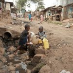 Unidentified boys take water on a street of Kibera, Nairobi, Kenya. Photo taken 2012. Source: istock Credit: vlad_karavaev