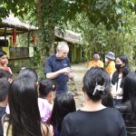 A man showing a simple groundwater experiment to schoolchildren