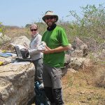 BGS geologists undertaking fieldwork to understand the formation of lithium deposits. Pictured holding a sample of lithium pegmatite from the Kamativi Pegmatite, Zimbabwe. BGS © UKRI