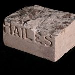 Carboniferous sandstone from Hailes Quarry, Edinburgh. The upper surface has been left in its natural state, showing the uneven bedding surface. Such samples were prepared by the quarry in order to market the stone. This sample dates from before the First World War. BGS © UKRI.