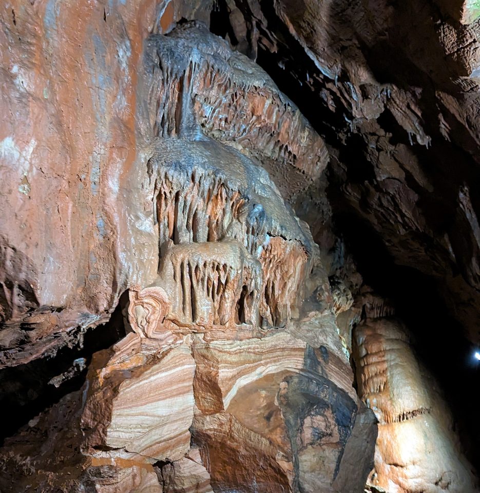 Victorian excavations involved destroying speleothems to gain access to the sediments buried beneath the stalagmite floors. The destruction reveals the layered nature of the floor, built up from drops of water depositing calcite over thousands of years.