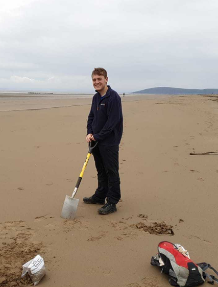 A man is digging on a beach