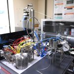 A close-up of the inlet on mass spectrometer. Frost is forming around the internal 'cold finger', which is in the process of freezing a sample of gas to remove impurities. BGS © UKRI.