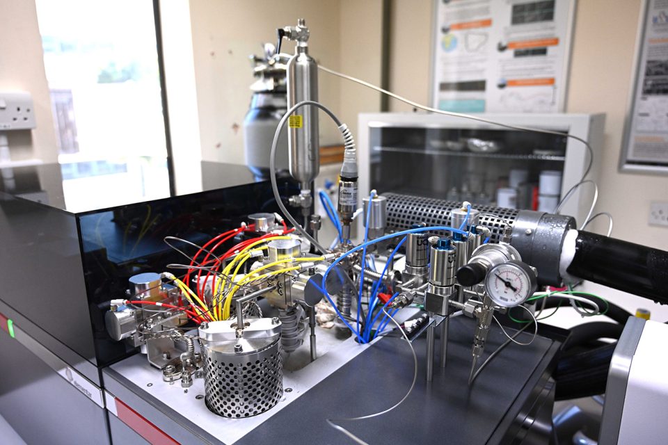 A close-up of the inlet on mass spectrometer. Frost is forming around the internal 'cold finger', which is in the process of freezing a sample of gas to remove impurities. BGS © UKRI.