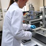Kotryna Savickaite loading sample vials into the hot block for stable-isotope mass spectrometry. BGS © UKRI.
