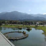 Wildlife wetland at the Great Chaozhou Artificial Lake managed groundwater recharge scheme in Pingtung County. One of the sediment settlement ponds can be seen behind the road in the mid-distance and, in the far distance, the foothills of the Central Mountain Range, where the water intake for the scheme is located on the Kaoping River. © Kathryn Leeming