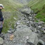 Examining debris flow deposits in the Codleteth Burn, Talla, Southern Uplands. BGS © UKRI.