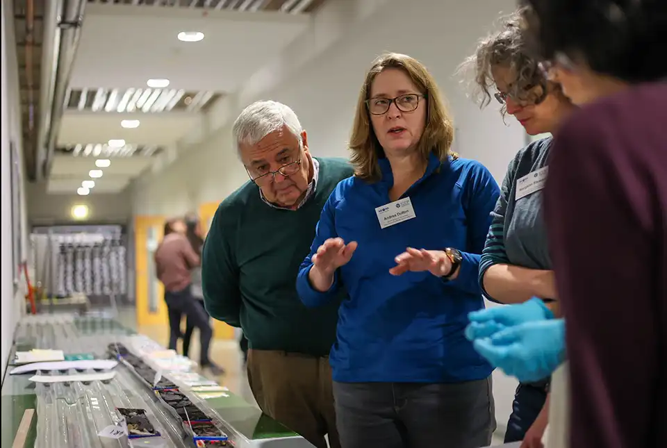 IODP Expedition 389 science party members, including BGS's Margaret Stewart (second from right), discussing cores. Marley Parker @ ECORD_IODP.