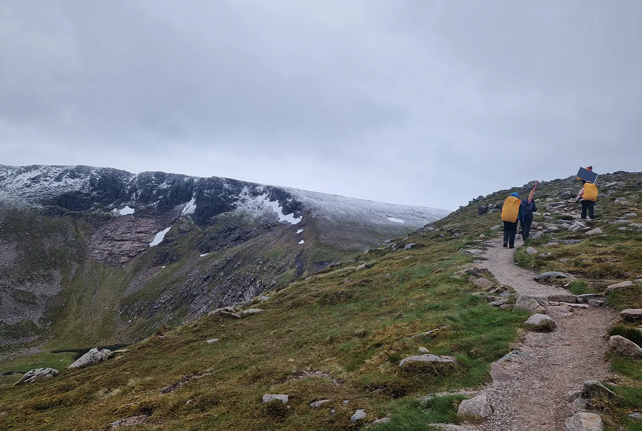 Geophysical instrumentation being carried up to Cairn Lochan (1216 m altitude) by the field team Photo credit: Innes Hamilton.