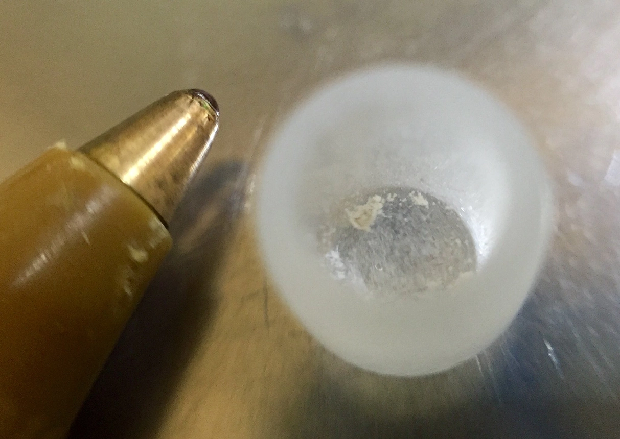 Figure 2b: a small carbonate sample weighed into a glass cup with a pen tip for scale reference. BGS © UKRI 2025.