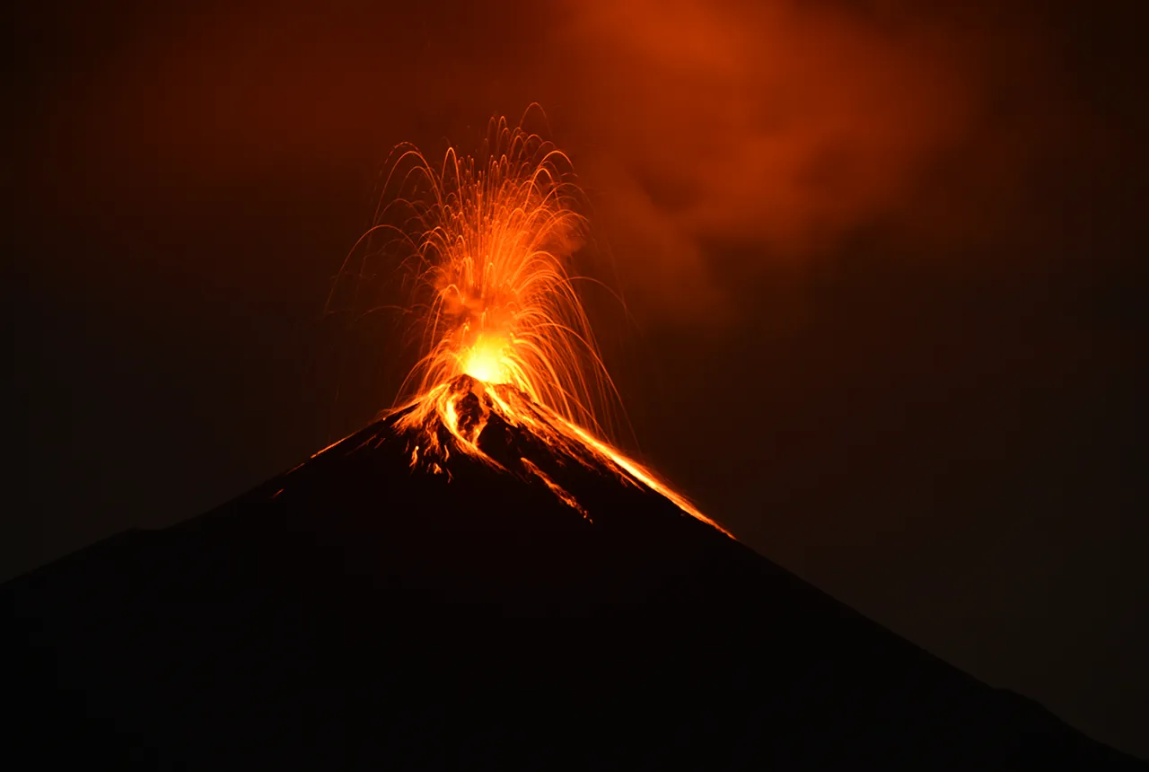 Fuego volcano with frequent activity that we could observe. This long exposure image shows how material is deposited on the high flanks of the volcano. BGS © UKRI.