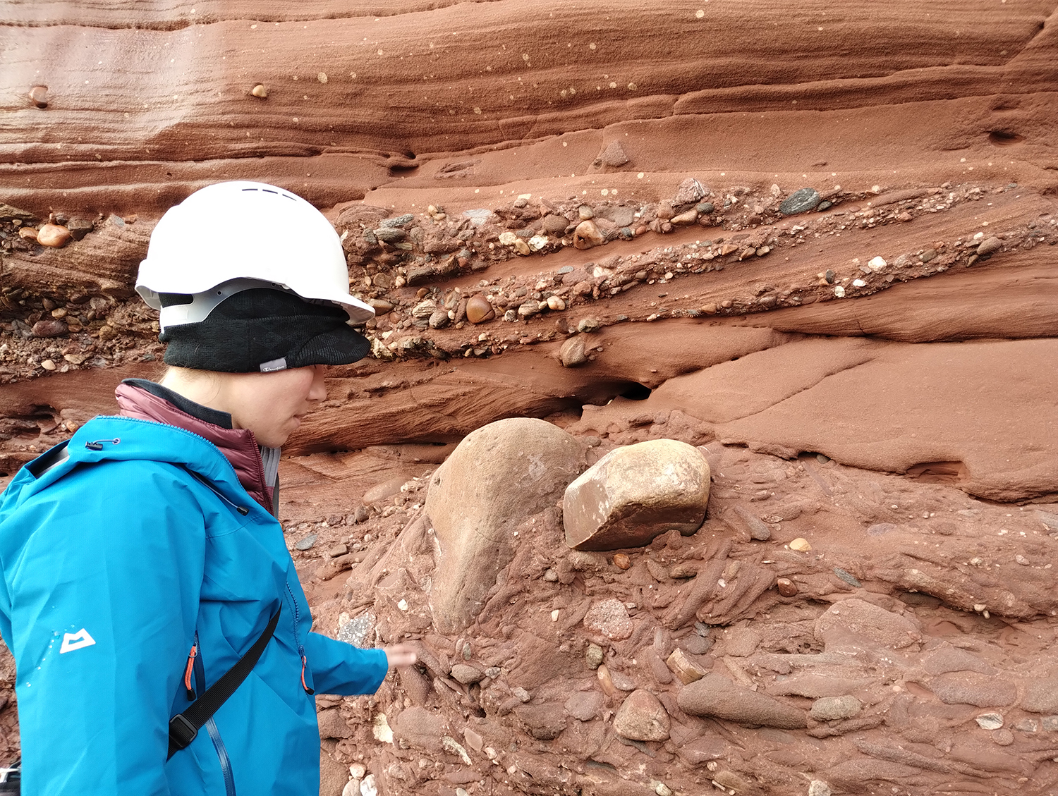 BGS Geoscientist studying the Devonian “Old Red Sandstone” at the Arbroath Cliffs, interpreting the environments in which these rocks were deposited.